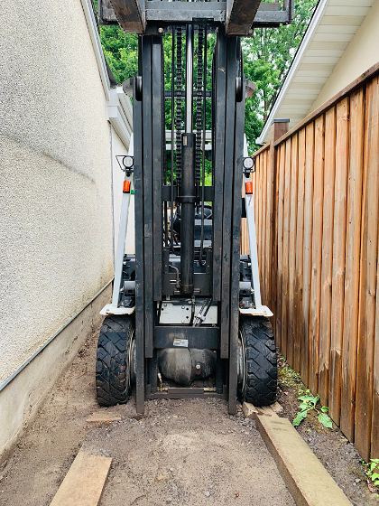 A forklift squeezed down the side passage