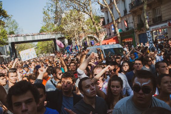 The boulevard packed, arms up